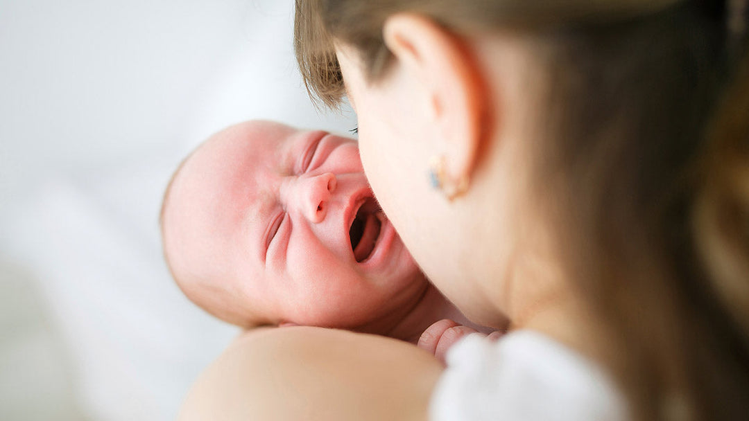 Parent comforting a baby with colic using gentle natural remedies